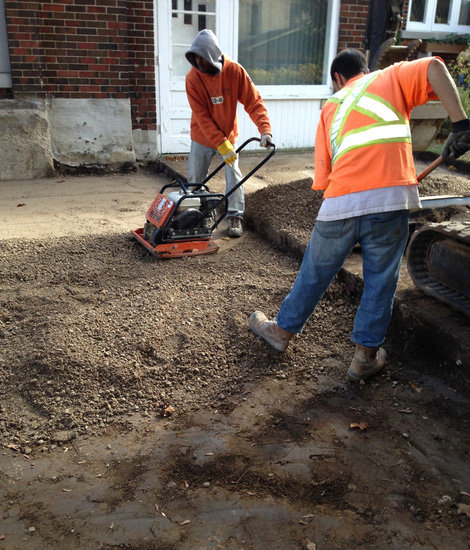 Men levelling out soil.